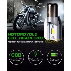 Żarówka LED 6W z trzonkiem BA20 D obok motocykla w ciemnym garażu