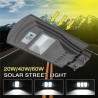 Szara latarnia solarna na mocowaniu ściennym z panelem solarnym i wbudowanym czujnikiem ruchu